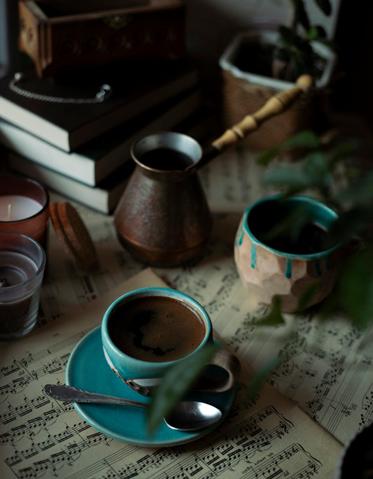 a cup of coffee sitting on top of a blue saucer