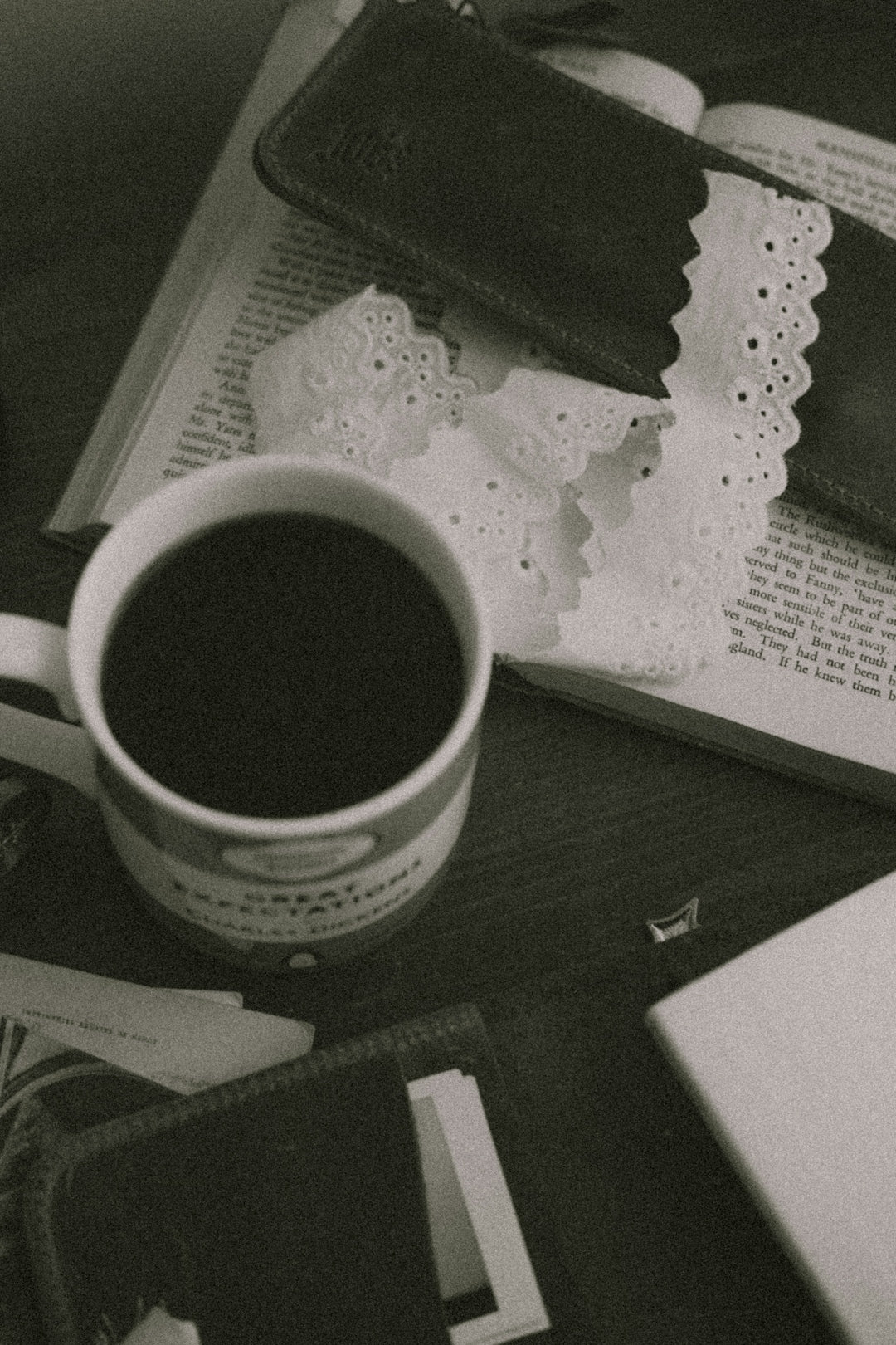 A mug of coffee rests on an open book.